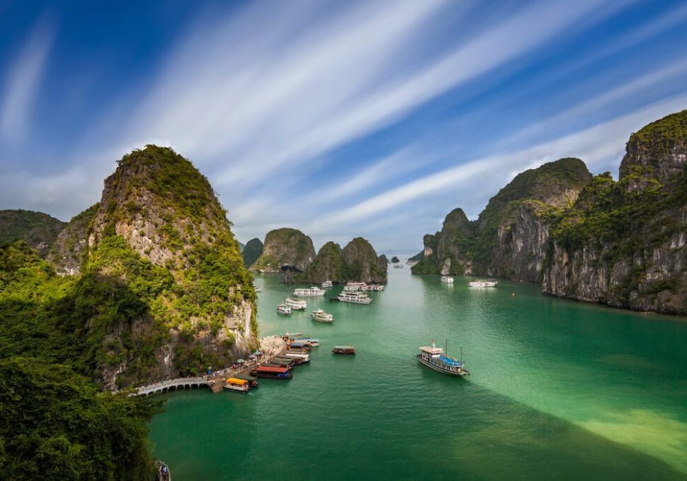 Baie d'Ha Long au Vietnam avec ses îlots karstiques et bateaux de croisière de luxe sur eaux émeraude